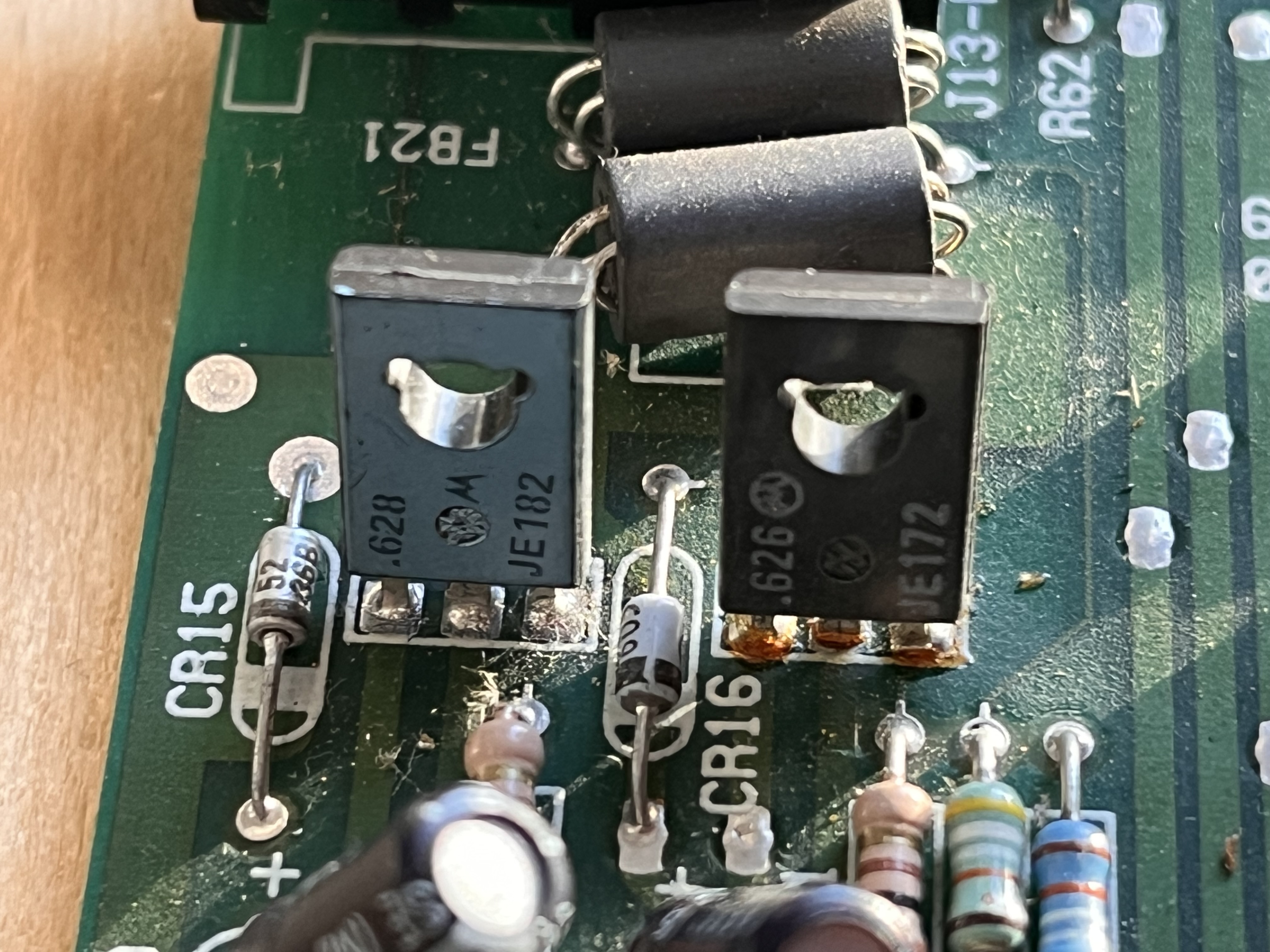 Q10 and Q11 transistors after cleaning showing MJE182 and MJE172 markings clearly