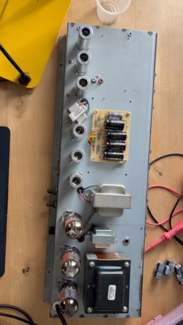 The reissue's cap board mounted in the chassis next to the output transformer and tube sockets