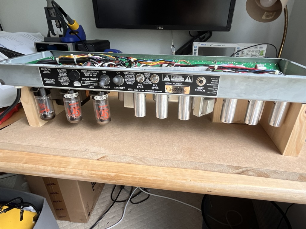 The reissue's chassis pulled for access, showing a denser PCB layout behind the panel