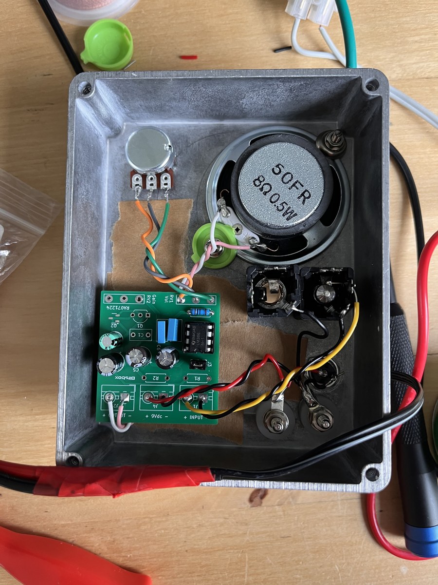 Inside the £4 Amp enclosure — LM386 PCB, speaker, and wiring