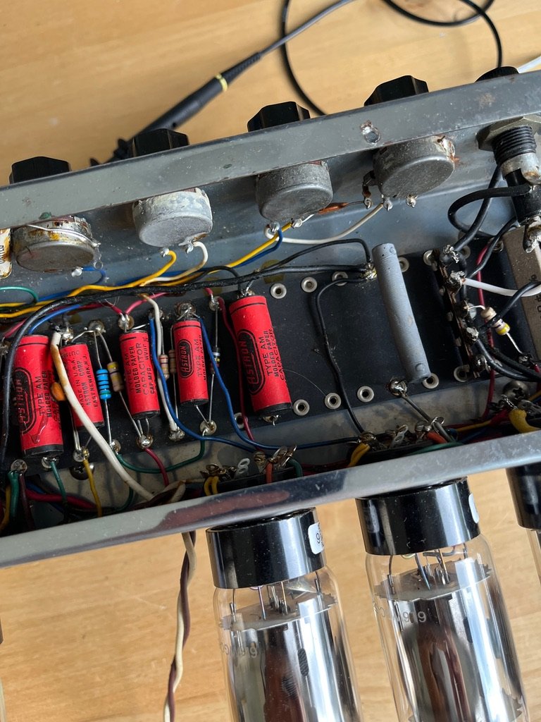 Amp interior showing filter capacitors, potentiometers and output valves during a full service