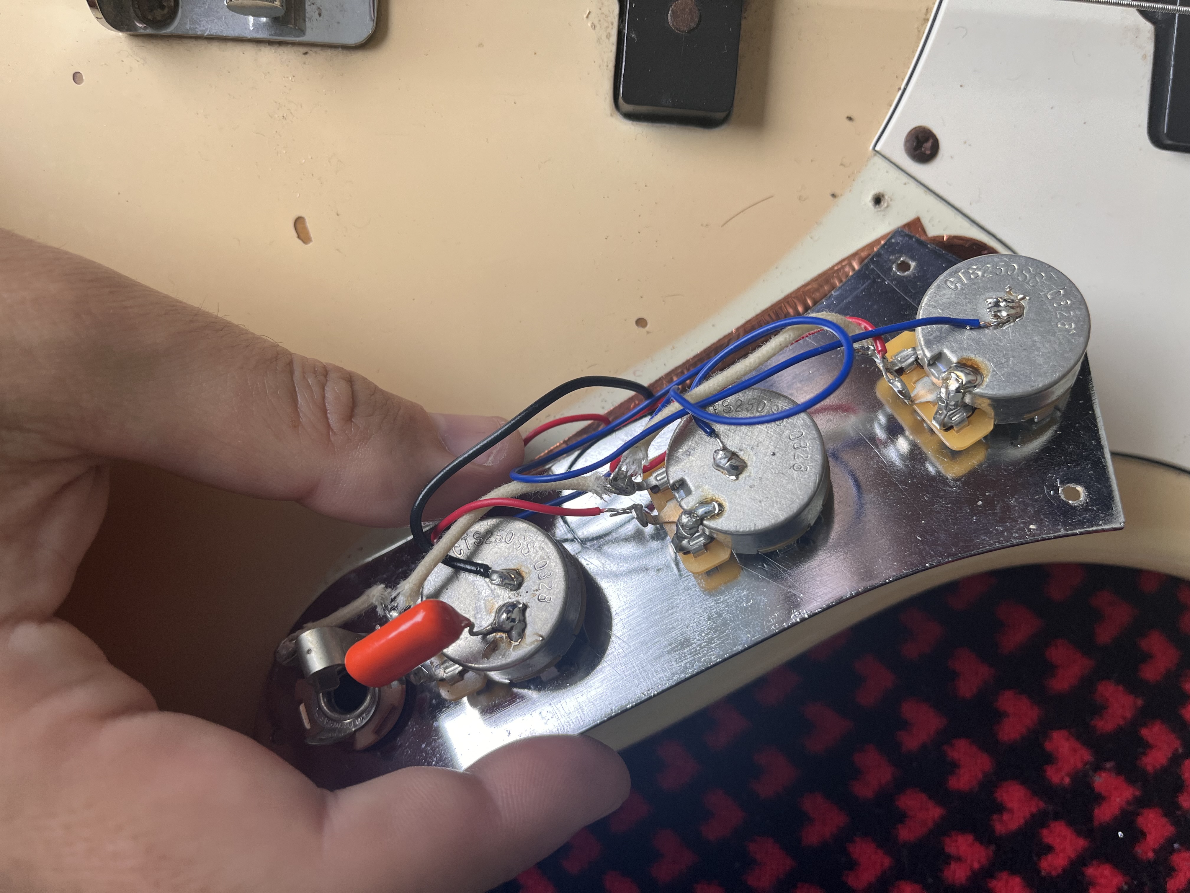 Stratocaster control plate with wiring exposed for inspection
