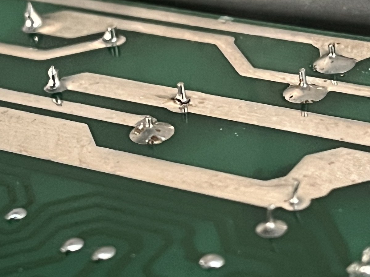 Close-up of dry joint on main filter cap, solder shrunk away from the pin