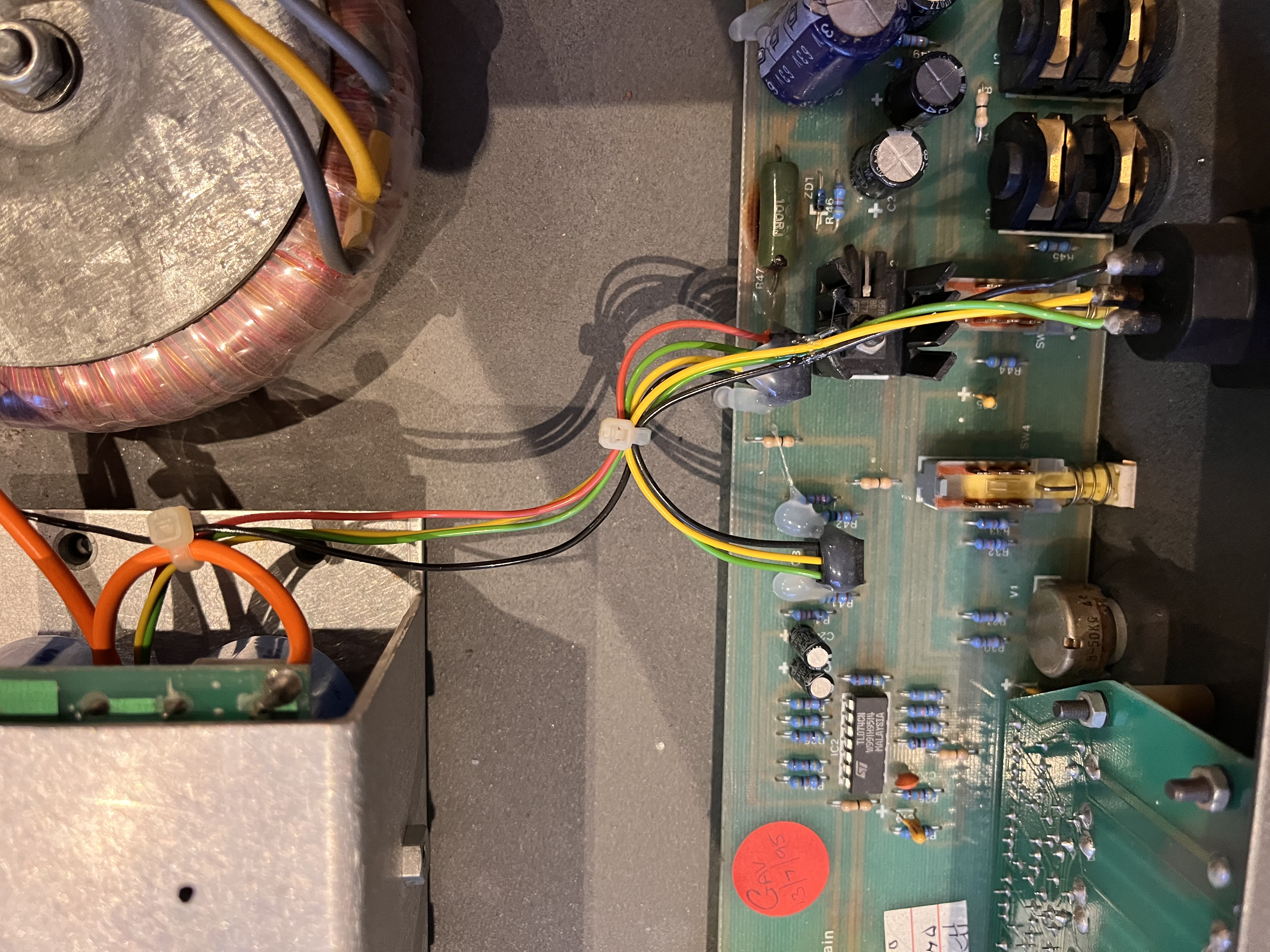 Inside a Trace Elliot bass amp showing the toroidal transformer and main PCB